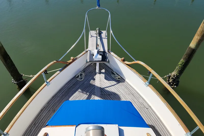 Slide: The Image of Bow view of 1983 Grand Banks 36 Classic boat docked on calm water. - 41