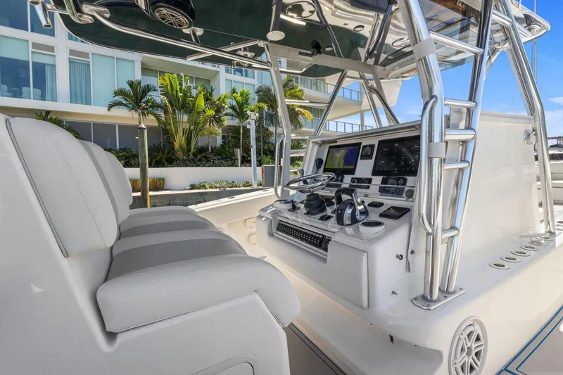 Slide: The Image of Four Mercury outboard engines on a 2013 Invincible 42 Open Fisherman boat, ocean view. - 18