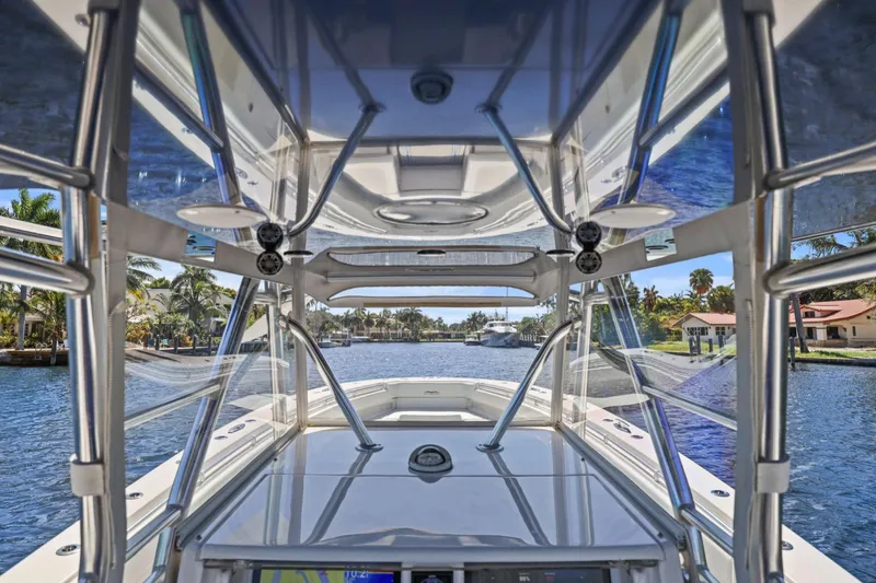 Slide: The Image of 2013 Invincible 42 Open Fisherman boat on open sea, clear sky, and calm waters. - 23