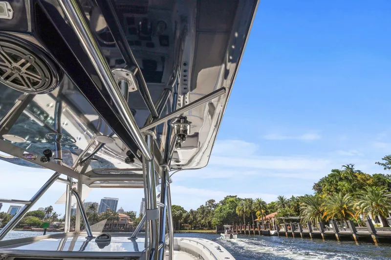 Slide: The Image of 2013 Invincible 42 Open Fisherman boat on ocean with city skyline in background. - 24
