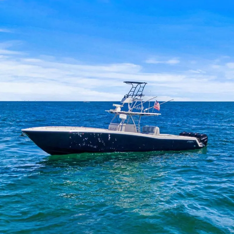 Slide: The Image of Invincible 42 Open Fisherman boat cruising near city skyline, 2013 model. - 5