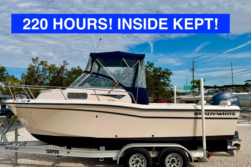 The Image of 2006 Grady-White Adventure 208 boat on trailer, 220 hours, inside kept, clear sky background. - 0