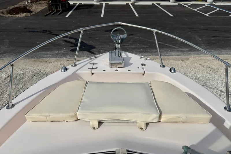 Slide: The Image of 2006 Grady-White Adventure 208 boat bow with cushioned seating and anchor setup. - 10