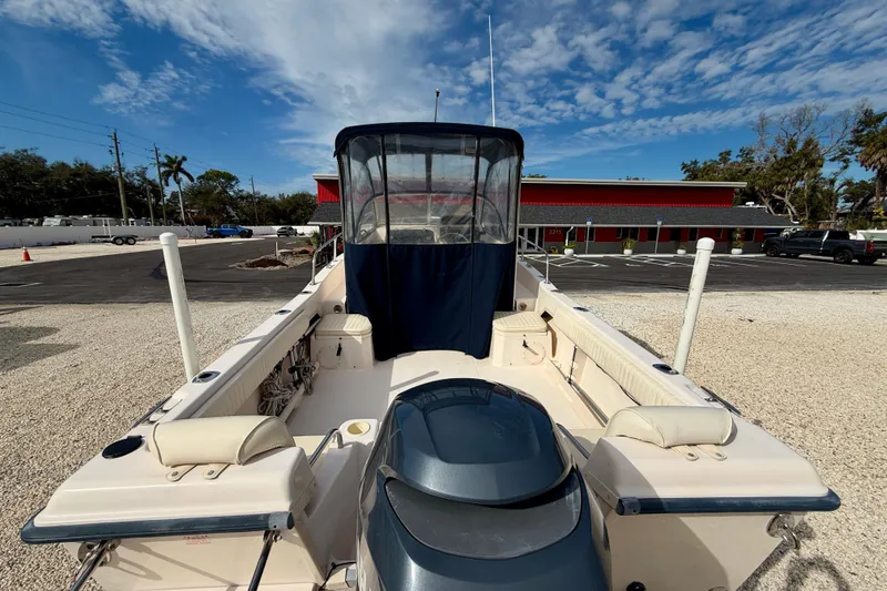 Slide: The Image of 2006 Grady-White Adventure 208 boat with canopy, parked on gravel under a blue sky. - 11