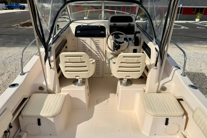 Slide: The Image of 2006 Grady-White Adventure 208 boat interior with dual seats and steering console. - 12