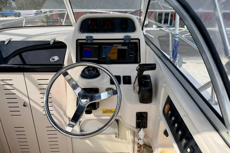 Slide: The Image of 2006 Grady-White Adventure 208 boat helm with steering wheel and navigation system. - 13