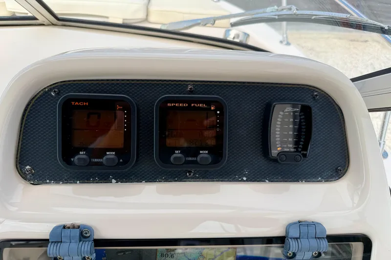 Slide: The Image of Dashboard of 2006 Grady-White Adventure 208 boat with tachometer and speed fuel gauges. - 16