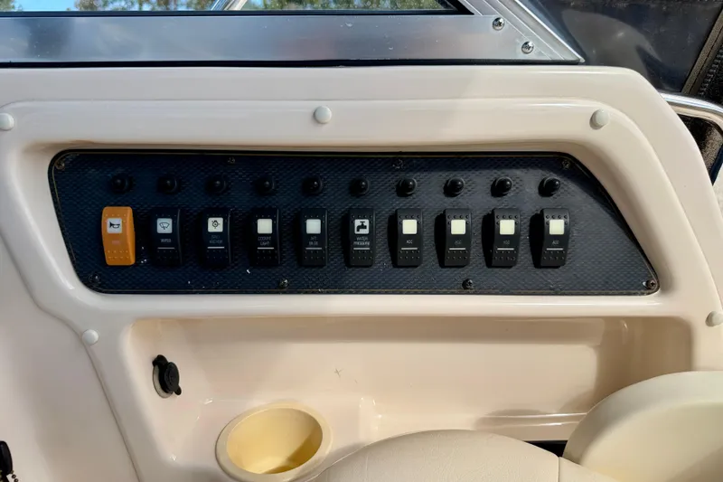 Slide: The Image of Control panel of a 2006 GRADY-WHITE Adventure 208 boat with labeled switches. - 19