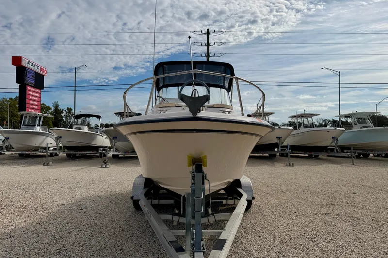 Slide: The Image of 2006 GRADY-WHITE Adventure 208 boat on trailer at dealership, clear sky background. - 2