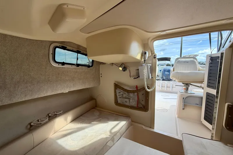Slide: The Image of Interior cabin of 2006 Grady-White Adventure 208 boat, featuring seating and storage. - 24