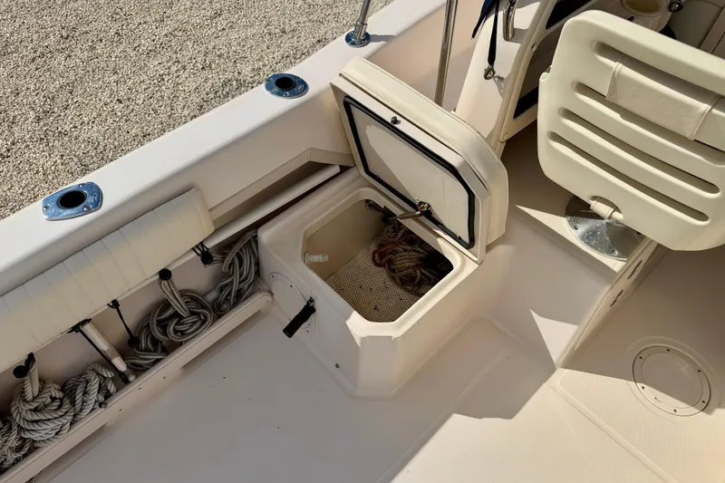Slide: The Image of 2006 Grady-White Adventure 208 boat interior with storage compartment and ropes. - 31