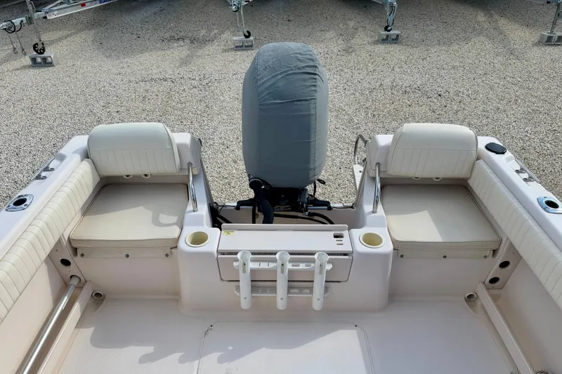 Slide: The Image of 2006 Grady-White Adventure 208 boat interior with cushioned seating and covered engine. - 35