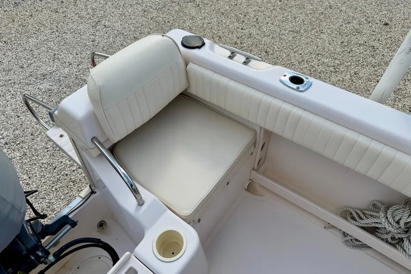 Slide: The Image of 2006 Grady-White Adventure 208 boat interior with cushioned seating and cup holder. - 37