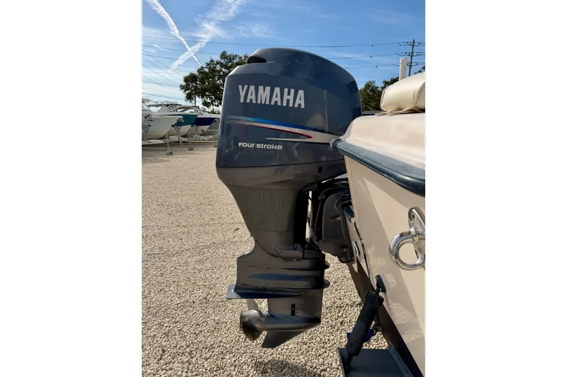 Slide: The Image of 2006 Grady-White Adventure 208 with Yamaha four-stroke outboard motor in a boatyard. - 41