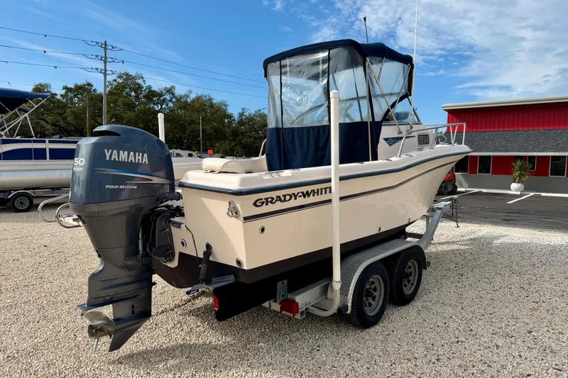 Slide: The Image of 2006 Grady-White Adventure 208 boat with Yamaha engine on trailer, outdoor setting. - 5