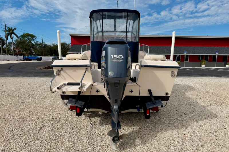 Slide: The Image of 2006 Grady-White Adventure 208 boat with Yamaha 150 outboard motor, parked on gravel. - 6
