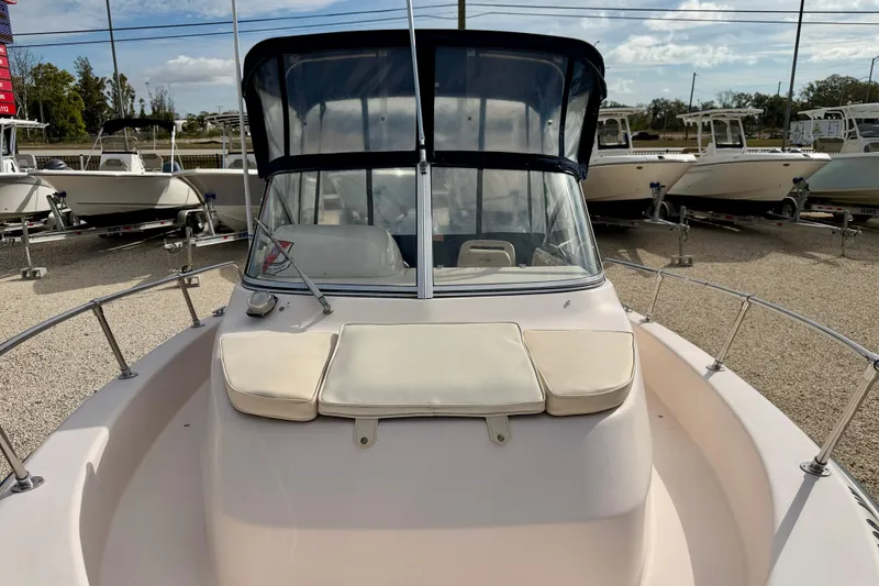 Slide: The Image of 2006 Grady-White Adventure 208 boat with cushioned bow, parked in a marina. - 9