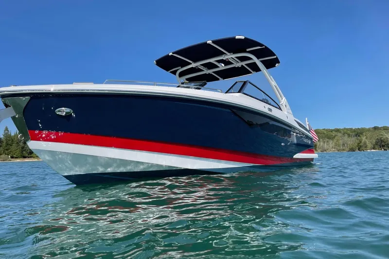 Slide: The Image of 2021 Cobalt A29 boat on clear blue water under a sunny sky. - 1