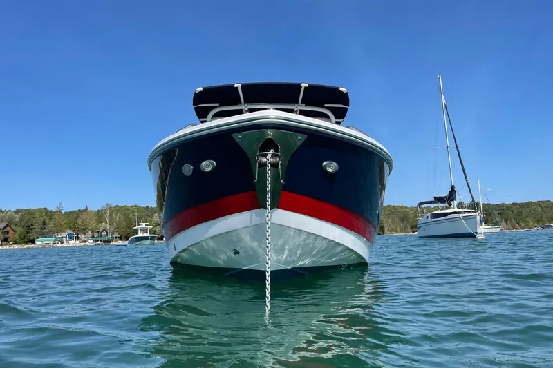 Slide: The Image of 2021 Cobalt A29 boat anchored on clear blue water, scenic background. - 2