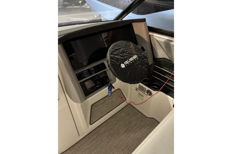 Slide: The Image of Interior of 2021 Cobalt A29 boat with covered steering wheel and control panel. - 11
