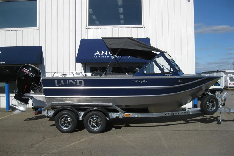 The Image of 2026 Lund 185 Heavy Gauge boat on trailer, side view, with outboard motor. - 0