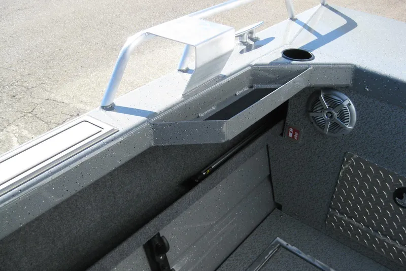 Slide: The Image of 2026 Lund 185 Heavy Gauge boat interior with storage compartments and speakers. - 11