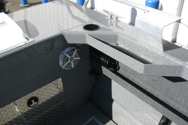 Slide: The Image of Interior view of 2026 Lund 185 Heavy Gauge boat, featuring speaker and cup holder. - 12