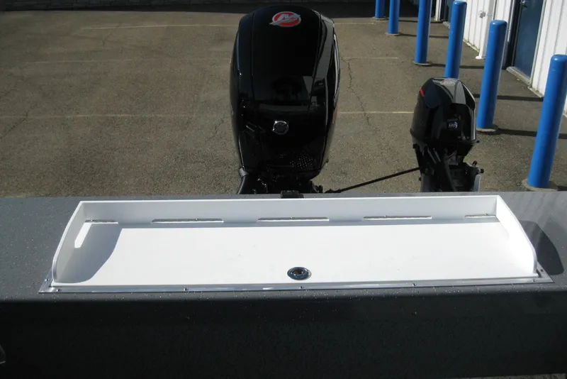 Slide: The Image of 2026 Lund 185 Heavy Gauge boat interior with speaker and cup holder. - 13