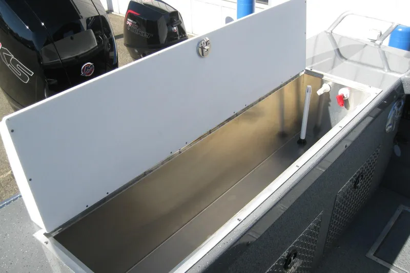 Slide: The Image of 2026 Lund 185 Heavy Gauge boat with dual outboard motors, docked on pavement. - 14