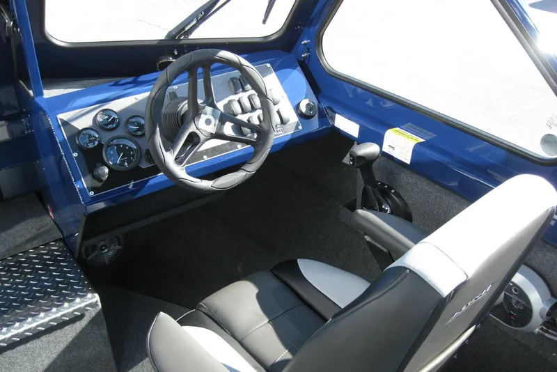 Slide: The Image of Interior of 2026 Lund 185 Heavy Gauge boat with blue accents and diamond plate details. - 18