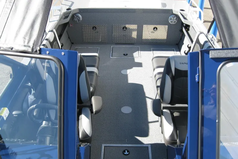 Slide: The Image of 2026 Lund 185 Heavy Gauge boat with diamond plate flooring and storage compartment. - 21