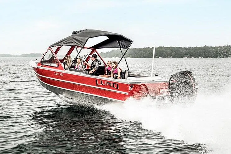 Slide: The Image of Manufacturer Provided Image: 2025 Lund 185 Heavy Gauge boat cruising with passengers on a lake. - 25