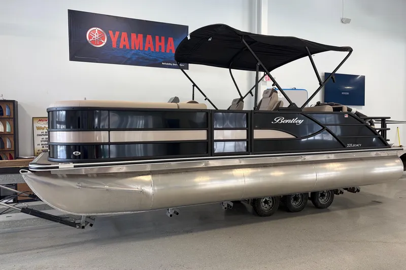 The Image of 2026 Bentley Pontoons Legacy 223 Swingback in showroom, featuring sleek design and Yamaha branding. - 0