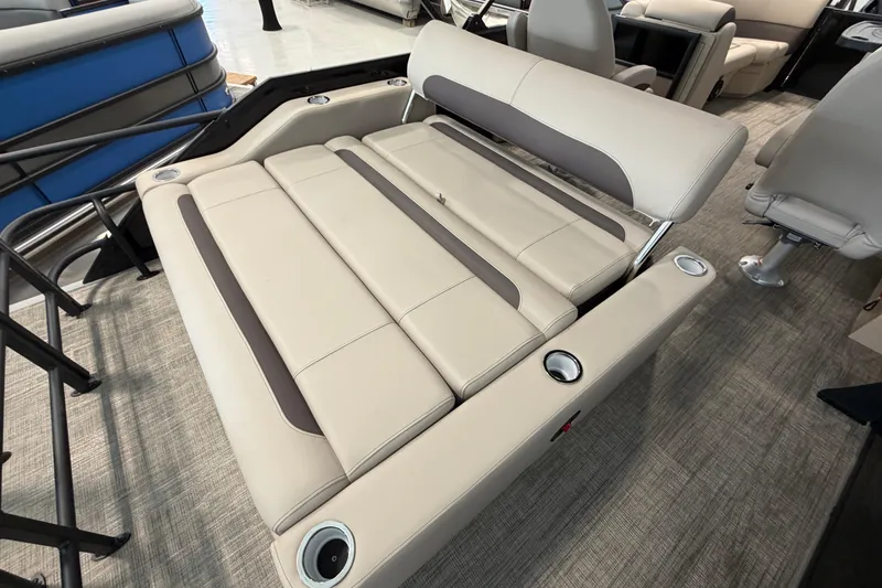 Slide: The Image of 2026 Bentley Pontoons Legacy 223 Swingback with luxurious beige seating and cup holders. - 7