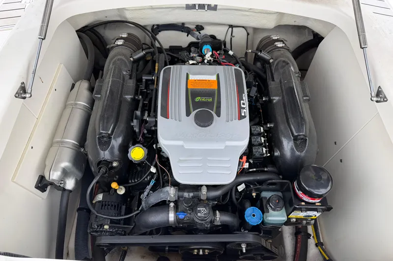 Slide: The Image of Engine compartment of a 2014 Chaparral 206 SSi boat, featuring a MerCruiser 5.0 MPI engine. - 13