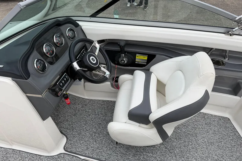 Slide: The Image of Interior of 2014 Chaparral 206 SSi boat showing steering wheel and dashboard controls. - 14