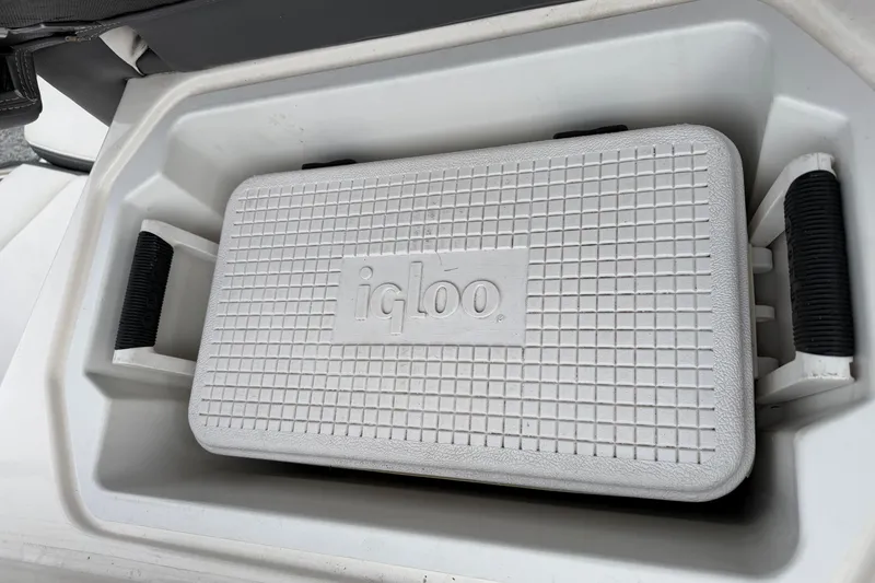 Slide: The Image of White Igloo cooler inside 2014 Chaparral 206 SSi boat storage compartment. - 16