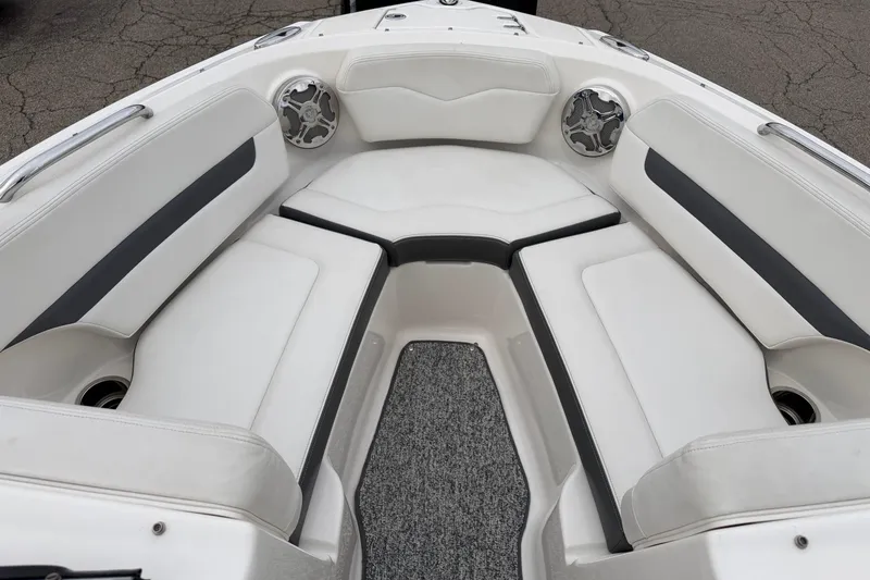Slide: The Image of 2014 Chaparral 206 SSi boat interior with white cushioned seating and speakers. - 8
