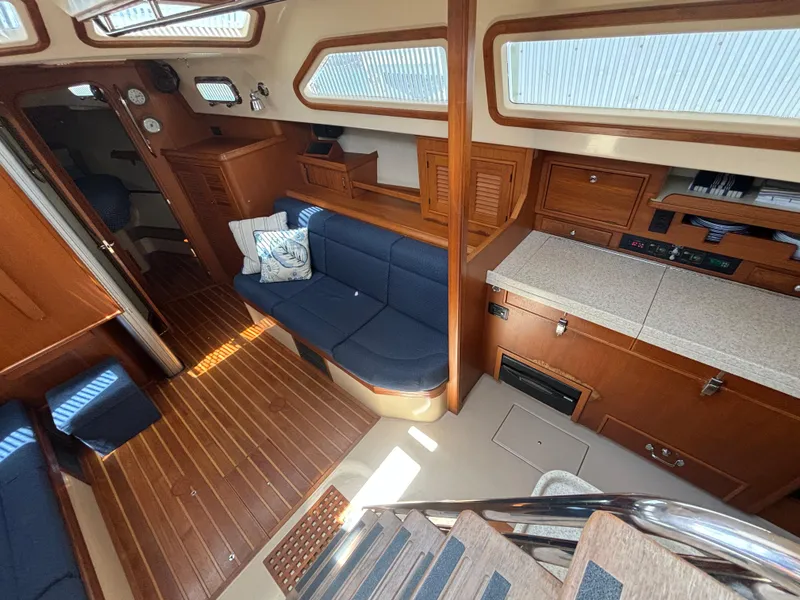 Slide: The Image of Interior of a 2005 Island Packet 445 yacht with wood floors and blue upholstery. - 11