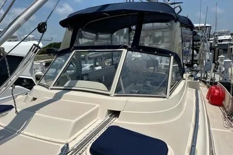 Slide: The Image of 2005 Island Packet 445 sailboat docked, featuring blue canopy. - 40