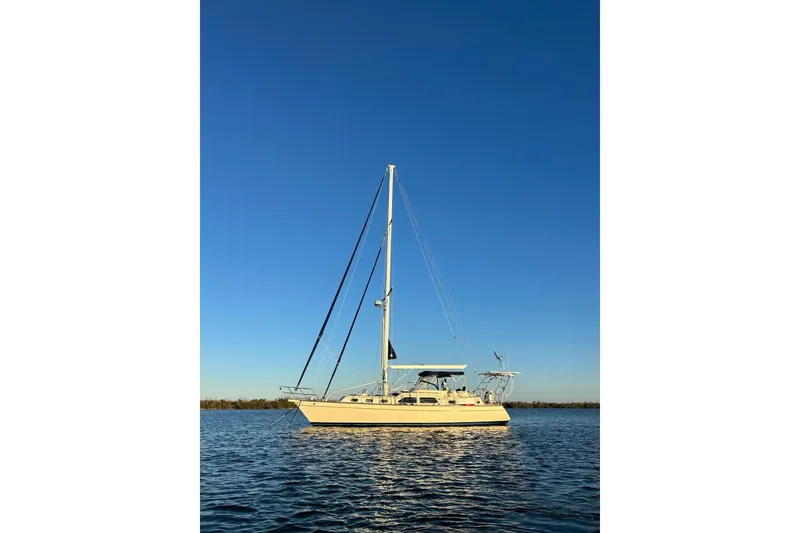 Slide: The Image of 2005 Island Packet 445 sailboat on calm water under clear blue sky. - 48