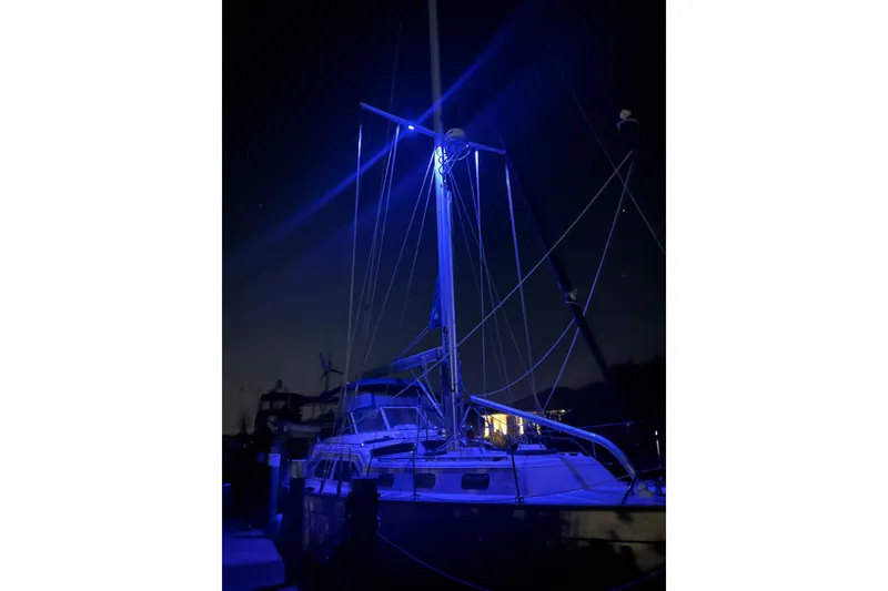 Slide: The Image of Sailboat Island Packet 445, 2005 model, illuminated at night with blue lighting. - 49