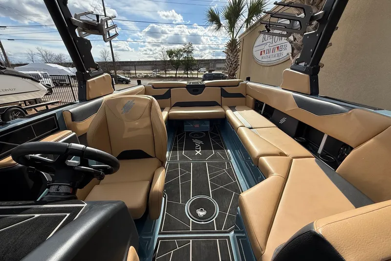 Slide: The Image of Luxurious 2023 ATX boat interior with tan leather seating and modern steering wheel. - 13