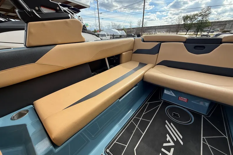 Slide: The Image of Luxurious 2023 ATX boat interior with tan and black seating, modern design. - 14