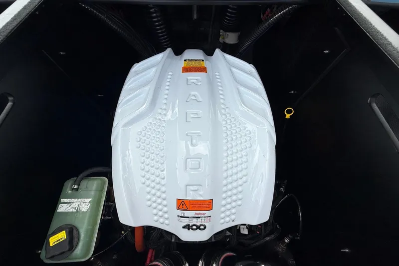 Slide: The Image of 2023 ATX Raptor 400 engine with white cover and warning labels. - 16