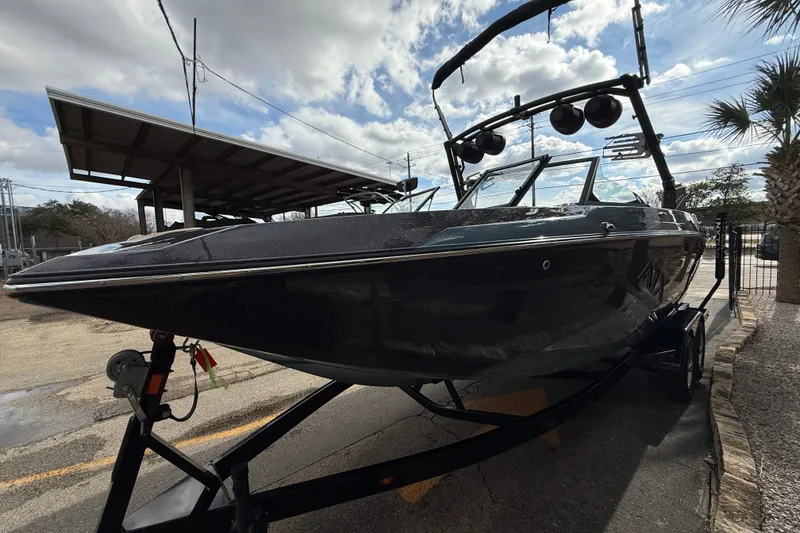 Slide: The Image of 2023 ATX Atx boat on trailer under cloudy sky, parked outdoors. - 3