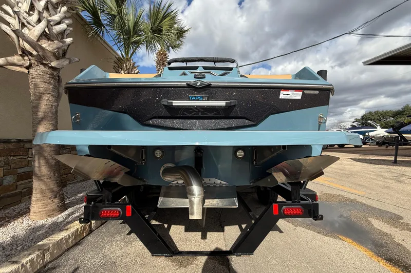 Slide: The Image of Rear view of a 2023 ATX boat model, parked outdoors under cloudy skies. - 5