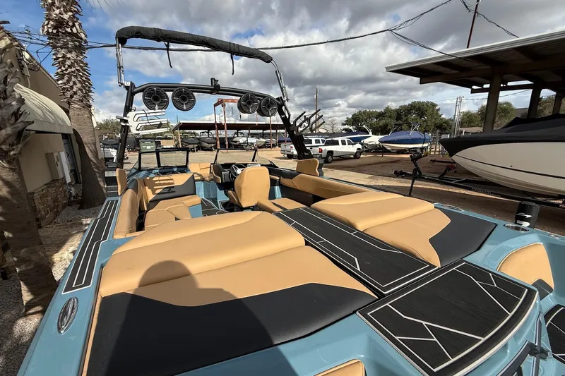 Slide: The Image of 2023 ATX Atx boat with tan and black interior, docked under cloudy skies. - 7