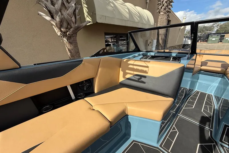 Slide: The Image of 2023 ATX boat interior with tan and black seating, modern design, and geometric flooring. - 9