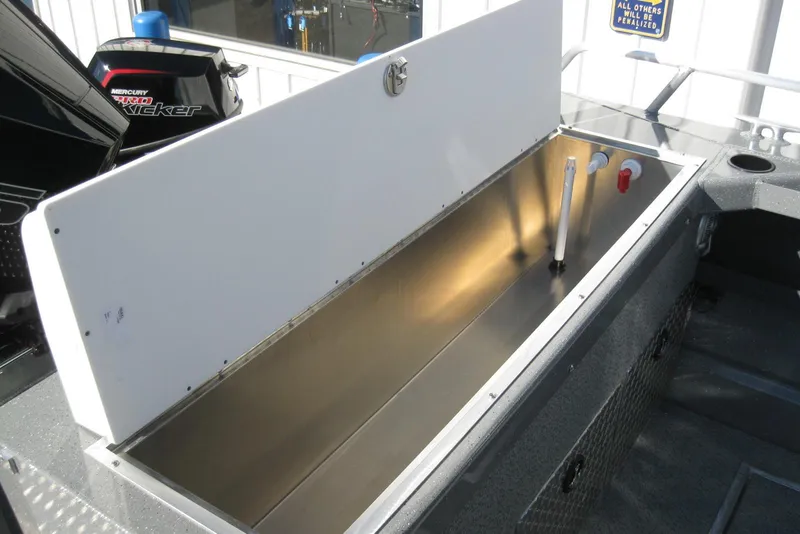 Slide: The Image of 2026 Lund 200 Heavy Gauge boat interior with storage compartments and diamond plate accents. - 13